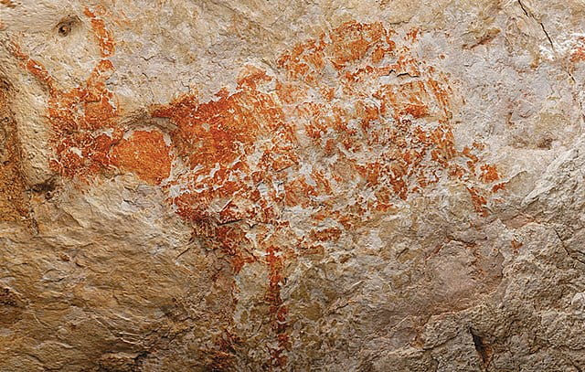 prehistoric rock art painting of bull Borneo