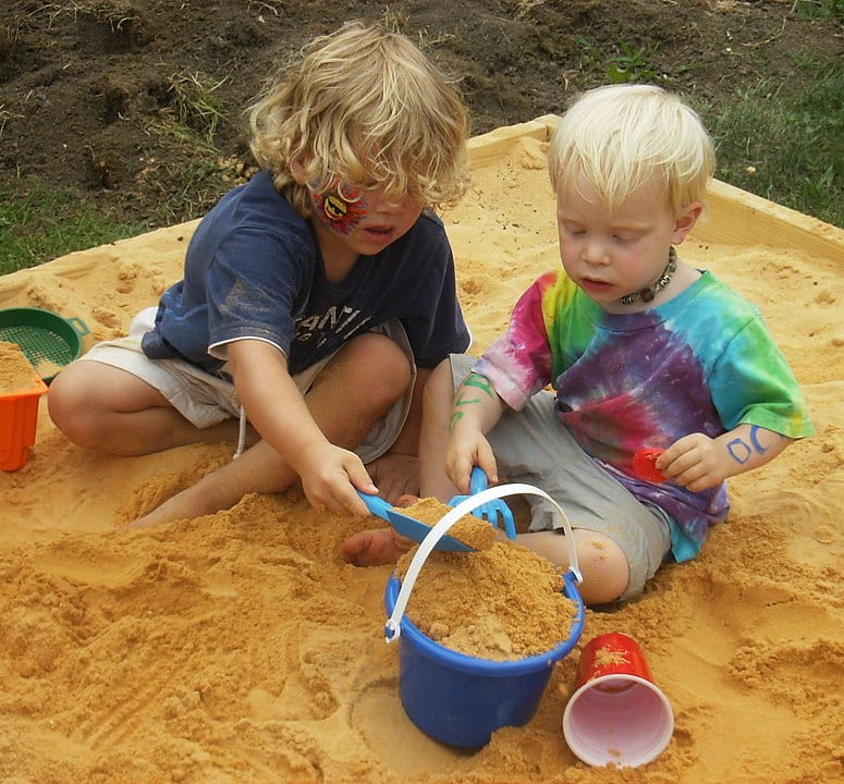 two children playing in sandbox