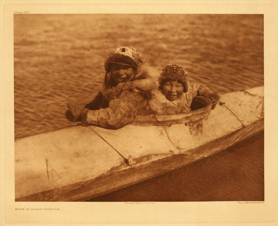 Inuit boys in kayak