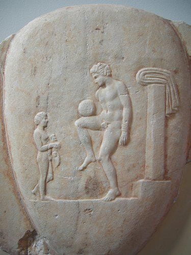 Ancient Greek football player with child