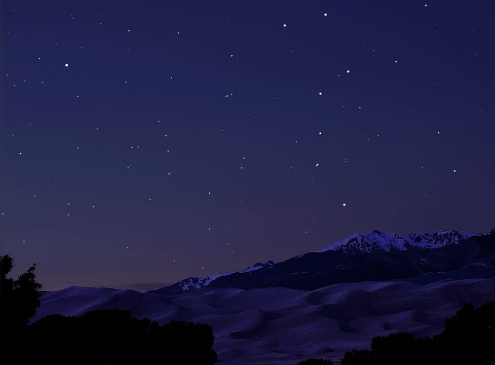 Big Dipper over dunes and mountains