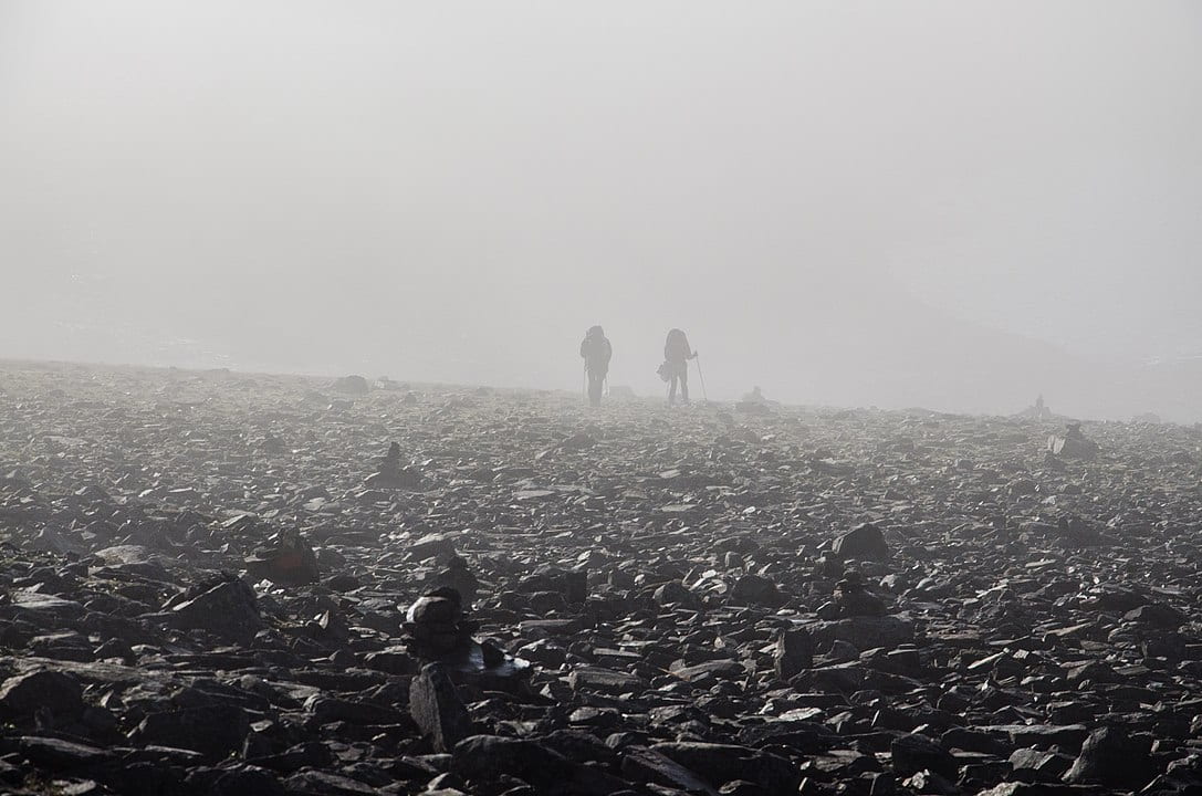 Mountain hikers in fog