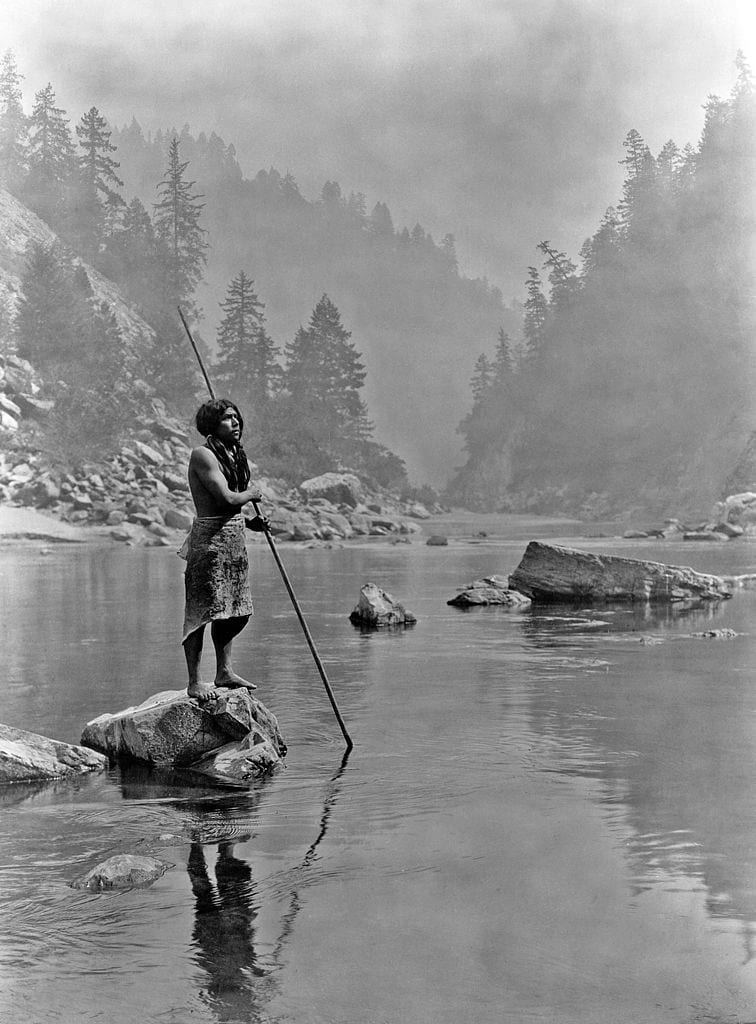Hupa man in river with spear