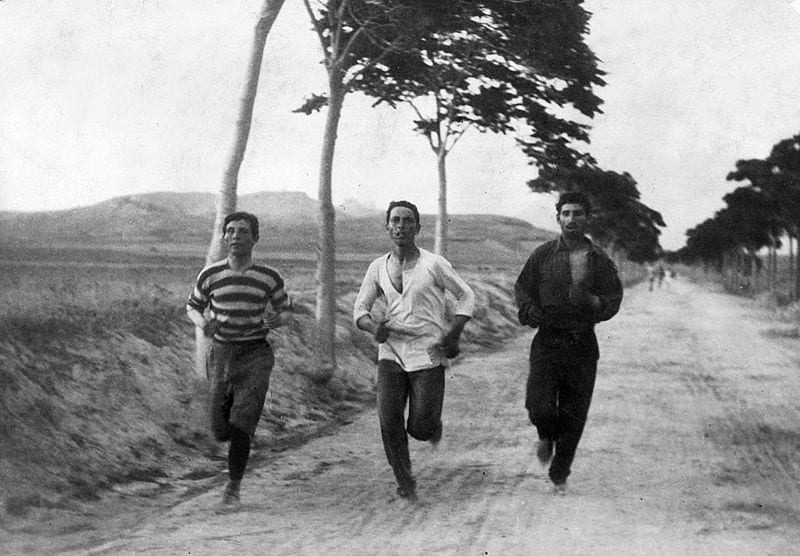 three men running on road