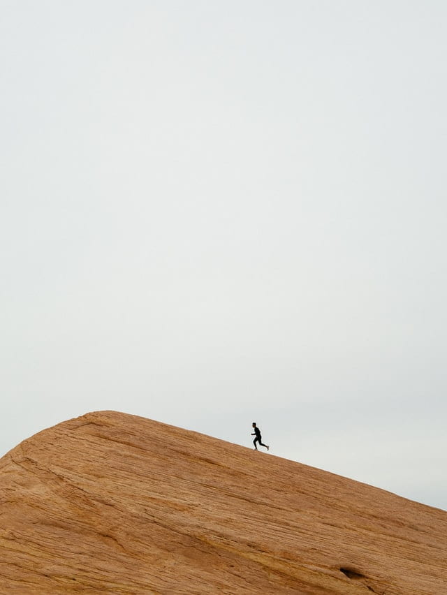 person running up a hill